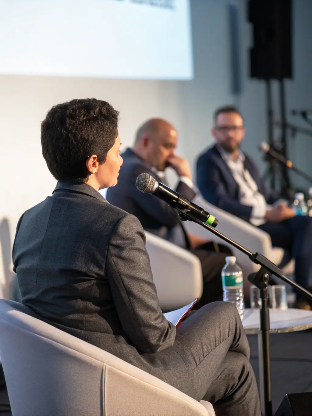 A photograph of a panel discussion featuring industry leaders discussing 'Navigating Brexit Challenges' at the BizSummit UK conference, showcasing diverse perspectives.